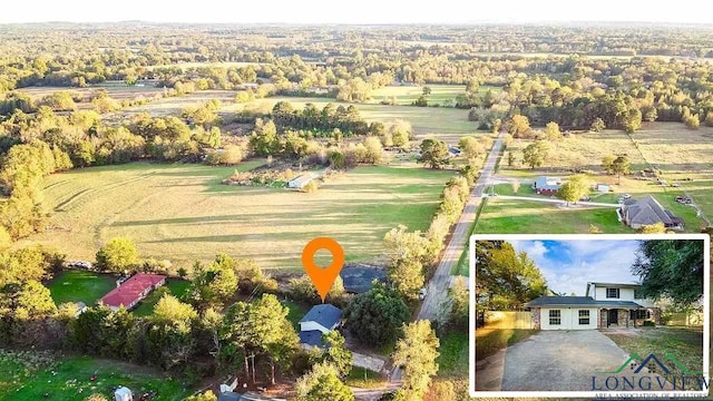 birds eye view of property featuring a rural view