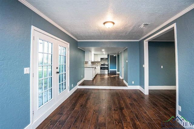 interior space featuring visible vents, crown molding, a textured wall, and dark wood-style flooring