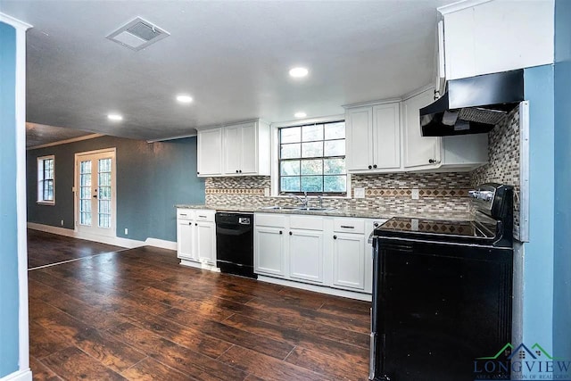 kitchen featuring decorative backsplash, visible vents, dark wood-type flooring, under cabinet range hood, and black appliances