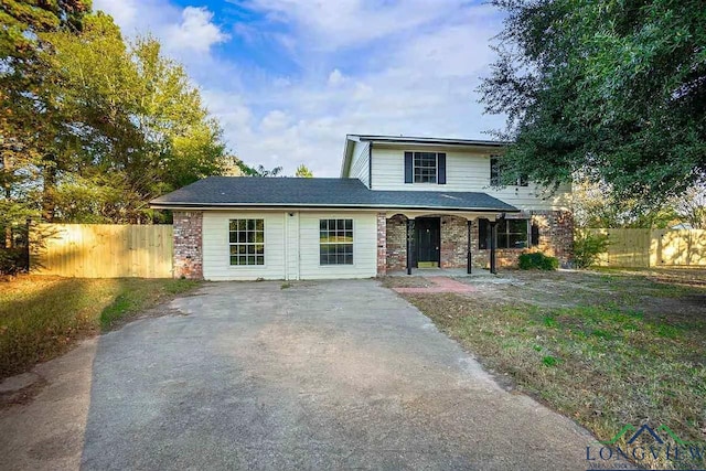 traditional home featuring fence