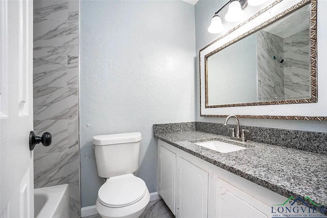full bath featuring baseboards, a textured wall, toilet, and vanity