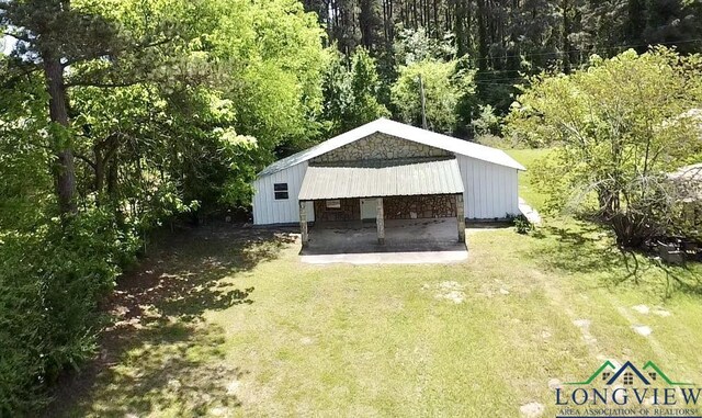 1435 Tom Smith Rd, Harleton, TX 75651 - view of outdoor structure featuring a forest view