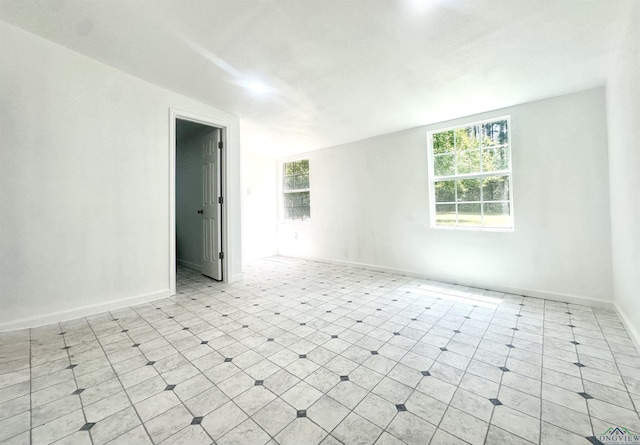 1435 Tom Smith Rd, Harleton, TX 75651 - spare room featuring healthy amount of natural light and baseboards