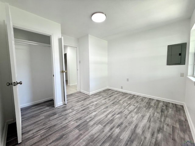 1435 Tom Smith Rd, Harleton, TX 75651 - unfurnished bedroom featuring electric panel, wood finished floors, baseboards, and a closet