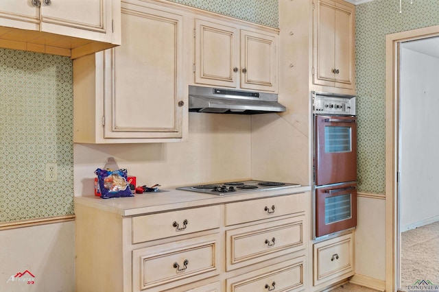 kitchen with gas stovetop, double oven, and cream cabinets