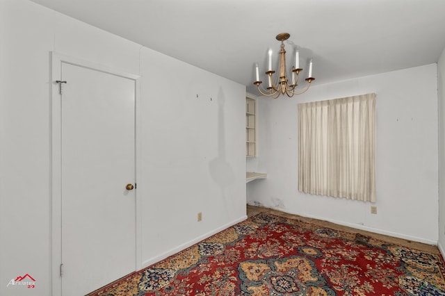 unfurnished dining area with a chandelier