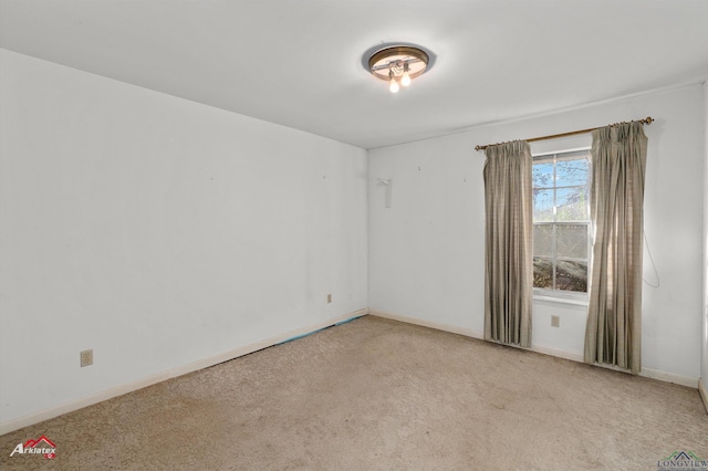 unfurnished room with light colored carpet