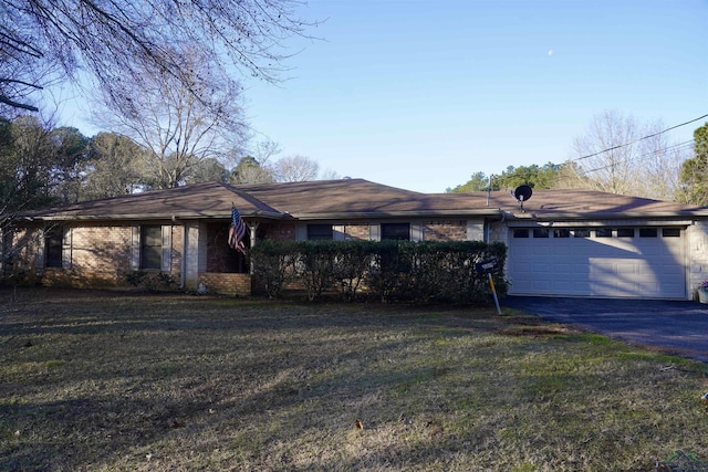 single story home featuring a garage, driveway, and a front yard