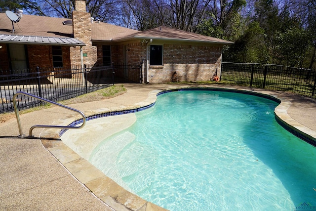 view of swimming pool with a patio area, fence, and a fenced in pool