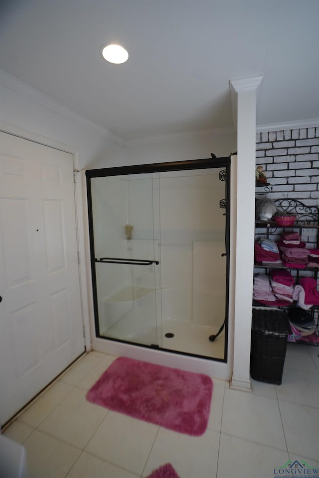 bathroom featuring tile patterned floors, a shower with shower door, and ornamental molding