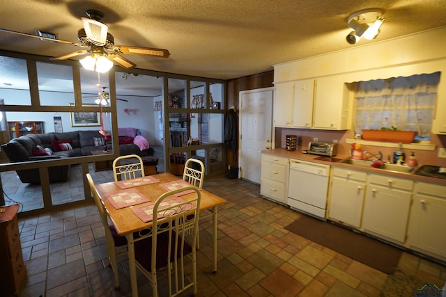 kitchen with sink, ceiling fan, white dishwasher, white cabinets, and a textured ceiling