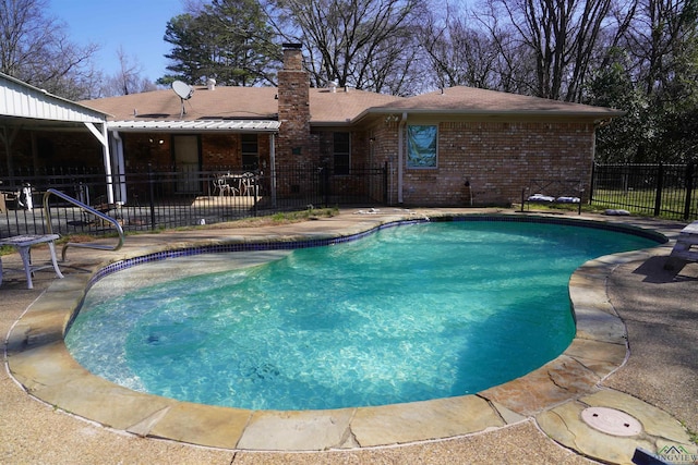 view of swimming pool with a patio, fence, and a fenced in pool