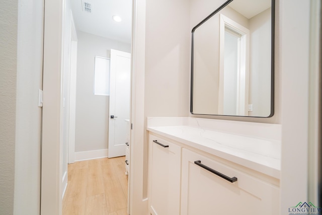 1101 Insignia Way, Longview, TX 75604 - bathroom with vanity, baseboards, recessed lighting, and wood finished floors