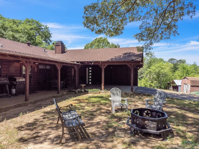 view of yard featuring a patio area and an outdoor fire pit