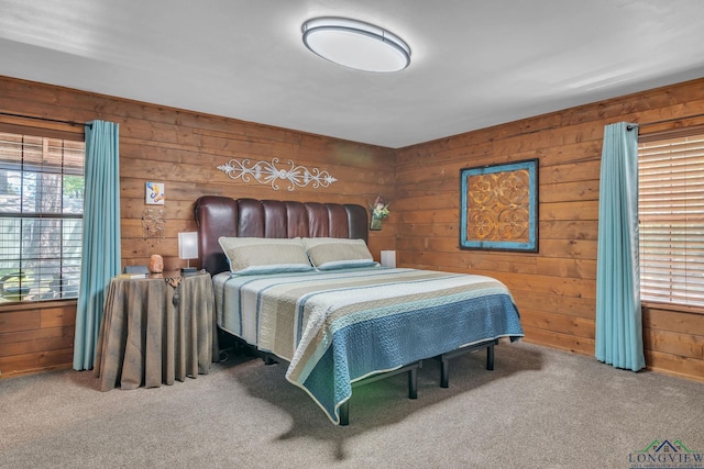 bedroom with carpet flooring and wooden walls