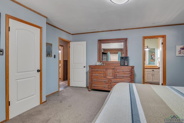 carpeted bedroom featuring ensuite bathroom, baseboards, and ornamental molding