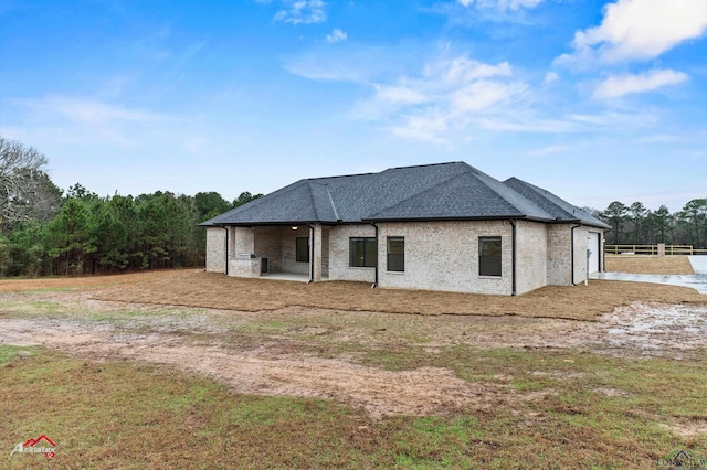 back of property featuring a yard and a patio