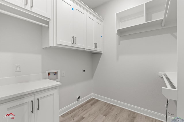 laundry room featuring cabinets, hookup for a washing machine, light hardwood / wood-style floors, and electric dryer hookup