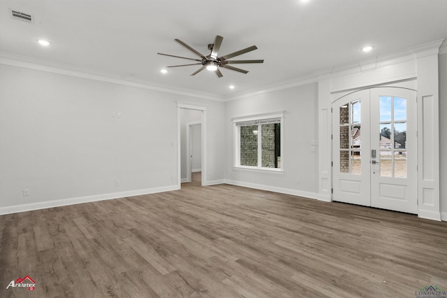unfurnished living room with hardwood / wood-style flooring, ornamental molding, ceiling fan, and french doors