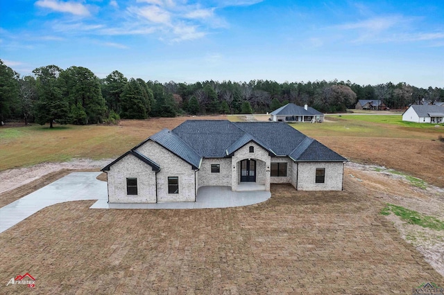 french country home with a front lawn