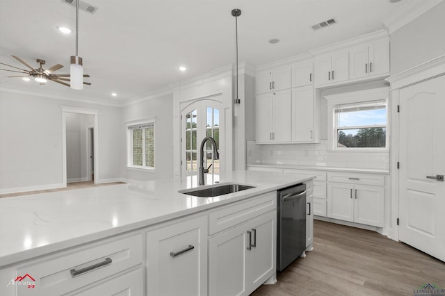 kitchen featuring dishwasher, sink, and white cabinets
