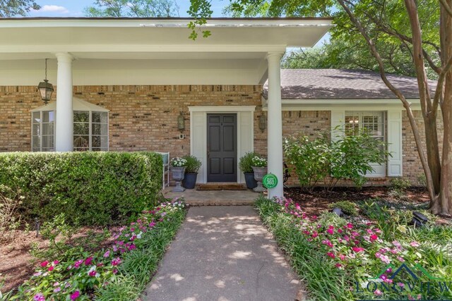 1805 Greenway St, Gilmer, TX 75644 - property entrance featuring brick siding and a porch