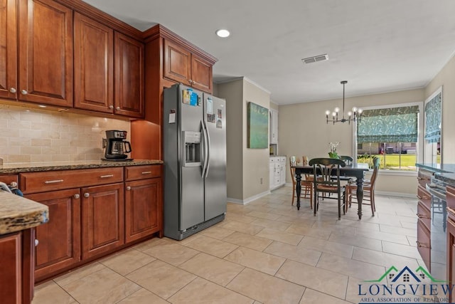 1805 Greenway St, Gilmer, TX 75644 - kitchen with stainless steel fridge with ice dispenser, baseboards, a chandelier, tasteful backsplash, and dark stone countertops