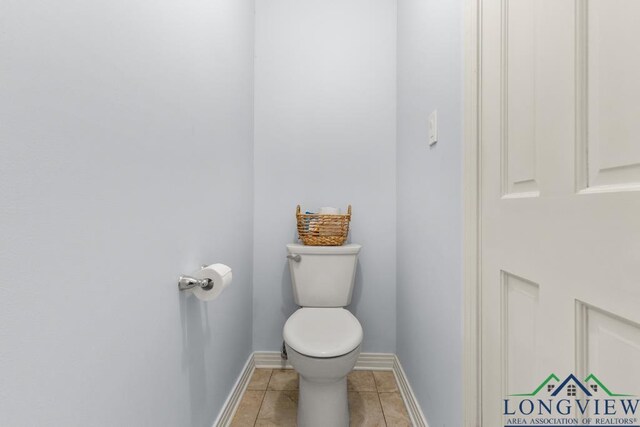 1805 Greenway St, Gilmer, TX 75644 - bathroom with toilet, tile patterned flooring, and baseboards