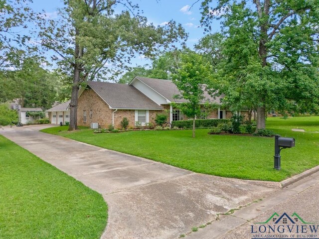 1805 Greenway St, Gilmer, TX 75644 - view of front of home with a front yard, brick siding, a garage, and roof with shingles