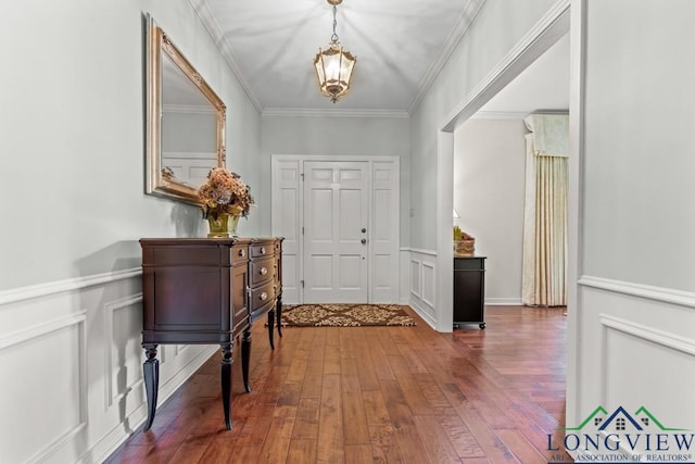 1805 Greenway St, Gilmer, TX 75644 - foyer entrance with hardwood / wood-style floors, ornamental molding, a wainscoted wall, a chandelier, and a decorative wall
