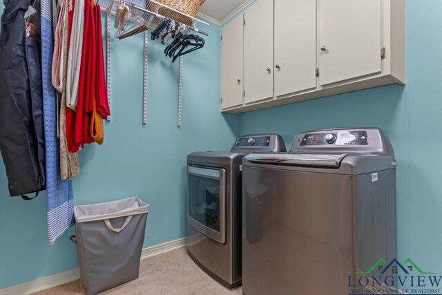 1805 Greenway St, Gilmer, TX 75644 - washroom featuring washing machine and dryer, cabinet space, and baseboards