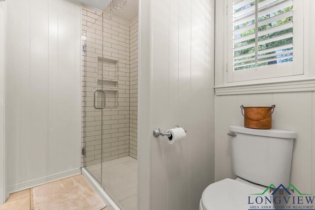 1805 Greenway St, Gilmer, TX 75644 - full bath with a shower stall, toilet, and tile patterned floors