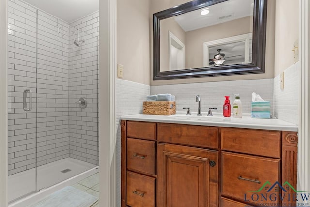 1805 Greenway St, Gilmer, TX 75644 - full bath with a stall shower, a ceiling fan, vanity, tile patterned floors, and tile walls