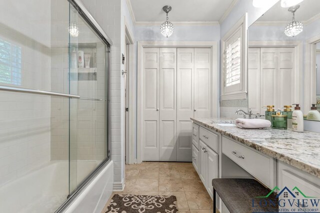 1805 Greenway St, Gilmer, TX 75644 - bathroom with vanity, combined bath / shower with glass door, crown molding, a closet, and tile patterned flooring