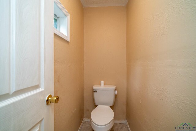 809 Herbert St, Marshall, TX 75670 - bathroom with baseboards and toilet
