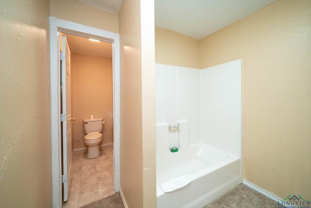 809 Herbert St, Marshall, TX 75670 - full bath featuring baseboards, a textured wall, and toilet