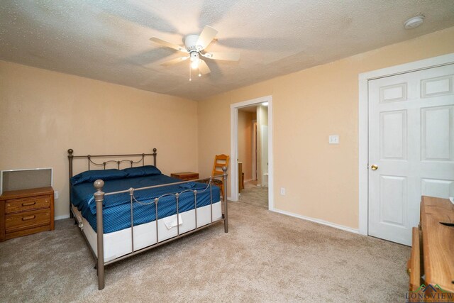 809 Herbert St, Marshall, TX 75670 - bedroom with carpet flooring, a ceiling fan, a textured ceiling, and baseboards
