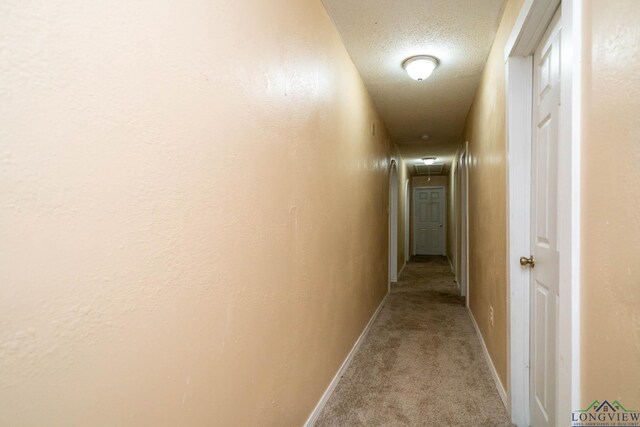 809 Herbert St, Marshall, TX 75670 - corridor featuring baseboards, attic access, carpet flooring, and a textured ceiling