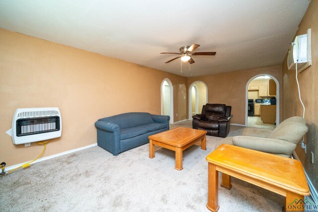 809 Herbert St, Marshall, TX 75670 - living area with ceiling fan, arched walkways, carpet, baseboards, and heating unit