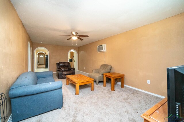 809 Herbert St, Marshall, TX 75670 - carpeted living room with arched walkways, ceiling fan, and baseboards