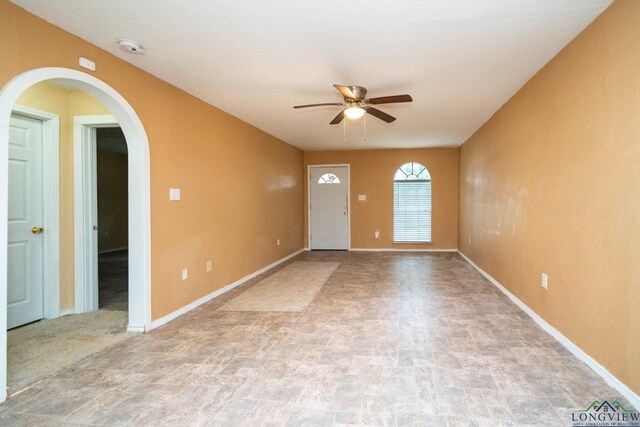 809 Herbert St, Marshall, TX 75670 - interior space with baseboards, a ceiling fan, and arched walkways