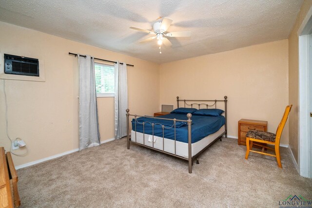 809 Herbert St, Marshall, TX 75670 - bedroom featuring carpet floors, a textured ceiling, baseboards, and an AC wall unit