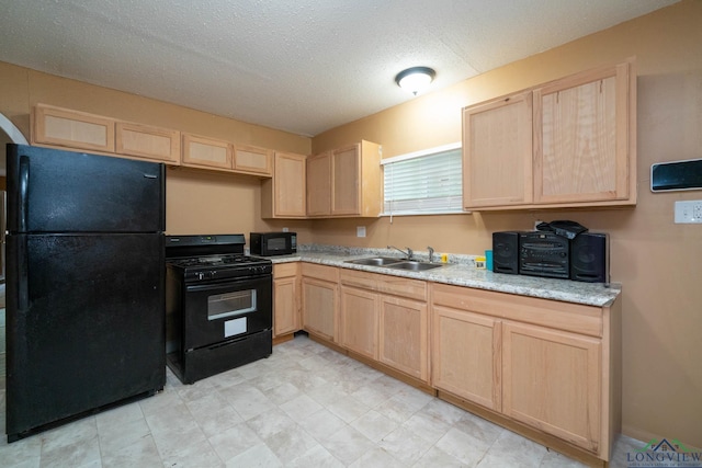 809 Herbert St, Marshall, TX 75670 - kitchen with a sink, a textured ceiling, black appliances, and light brown cabinets