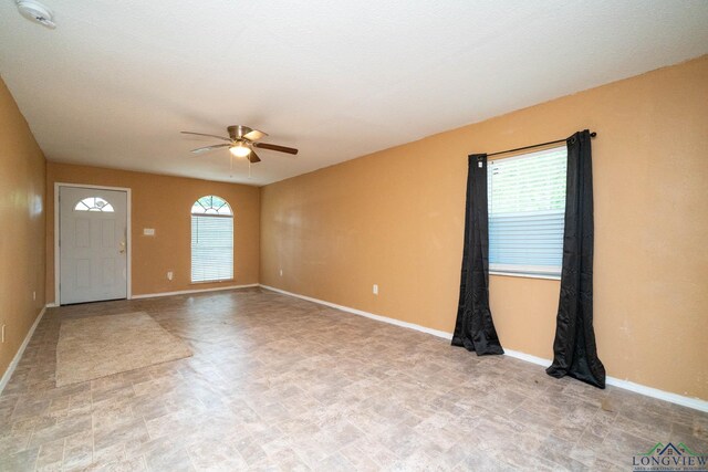 809 Herbert St, Marshall, TX 75670 - interior space with plenty of natural light, baseboards, and ceiling fan