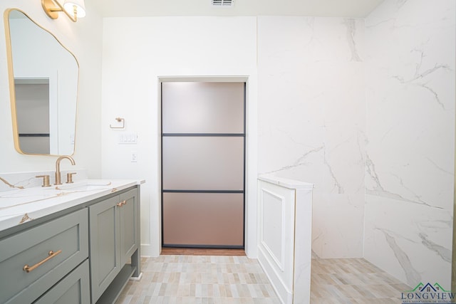 bathroom with vanity and walk in shower