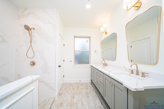 bathroom featuring vanity and tiled shower