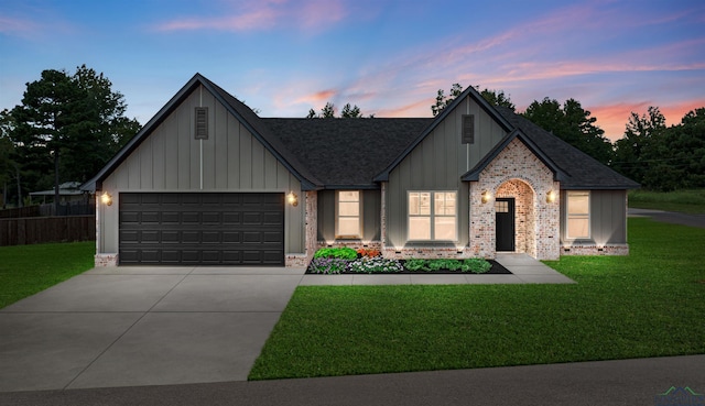 view of front of house with a garage and a lawn