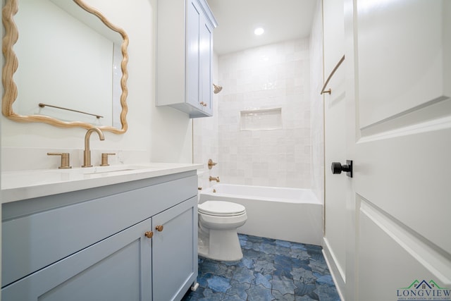 full bathroom with vanity, tiled shower / bath combo, and toilet