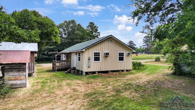 1150 Fm 139, Joaquin, TX 75954 - back of house featuring a lawn, an outdoor structure, and board and batten siding