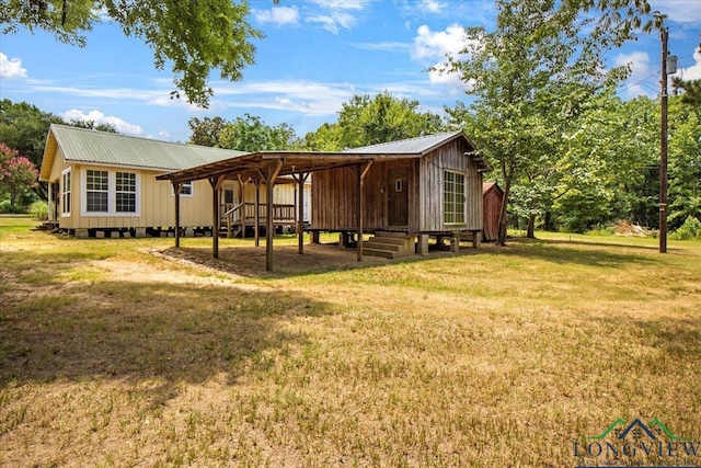 1150 Fm 139, Joaquin, TX 75954 - back of property with a metal roof, a yard, and a wooden deck